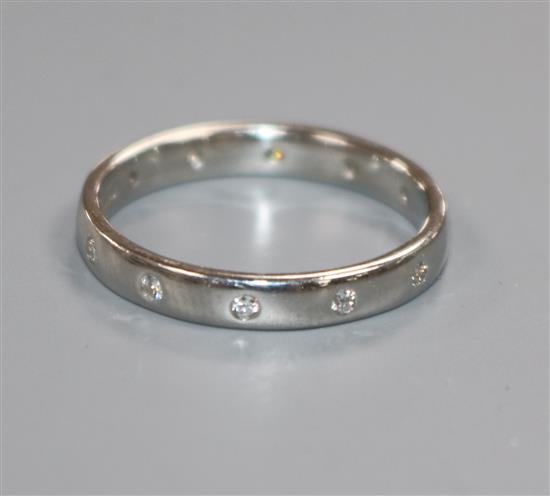 A modern platinum and gypsy set diamond eternity ring, size N.